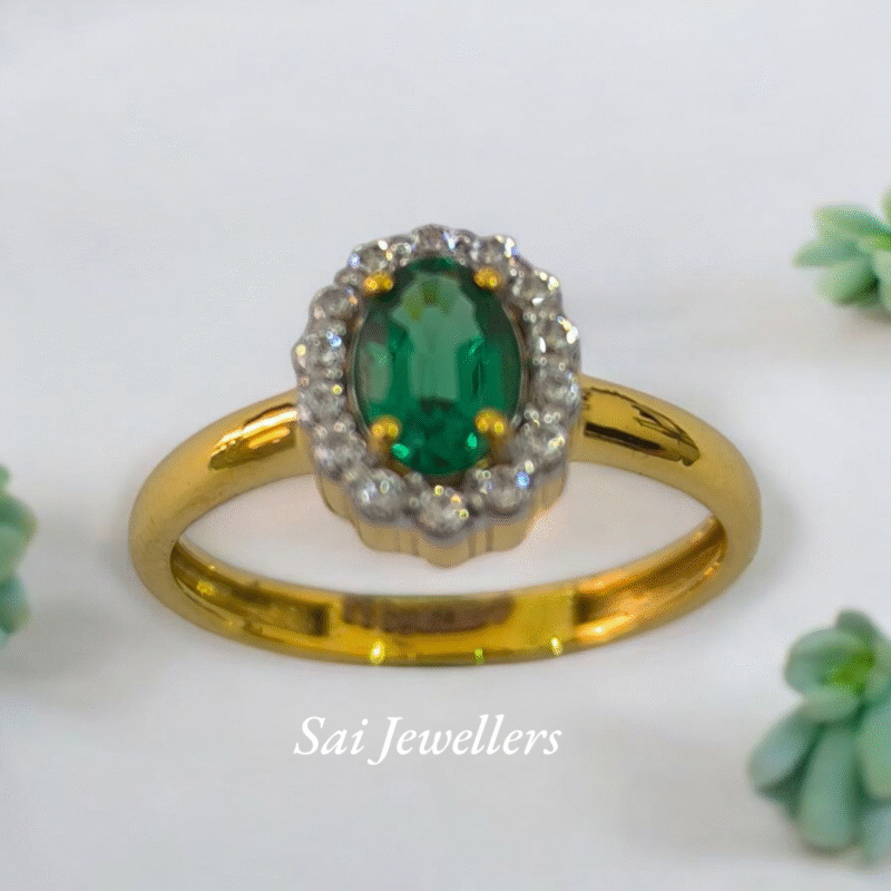 18K gold ring with oval 2.50ct green emerald surrounded by 0.20ct round diamonds in a halo setting, 2.220gm gold weight – Sai Jewellers.